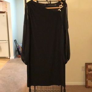 Cocktail dress with sheer peek a boo sleeves.